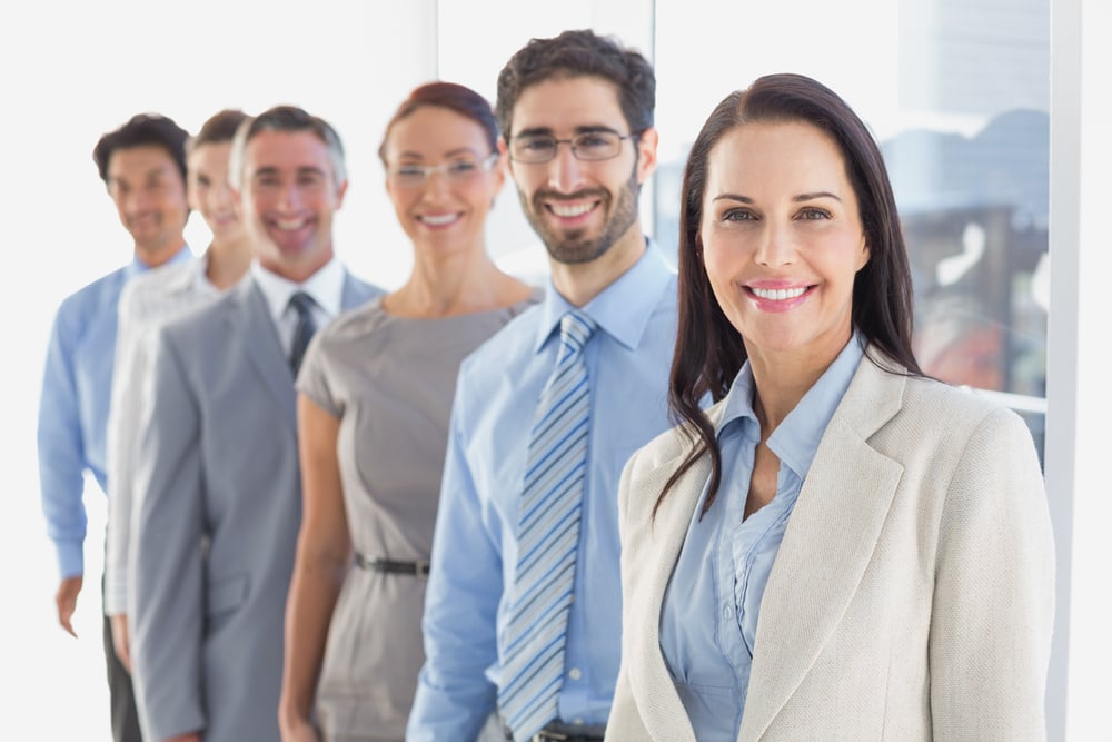 Smiling employees in a line at work